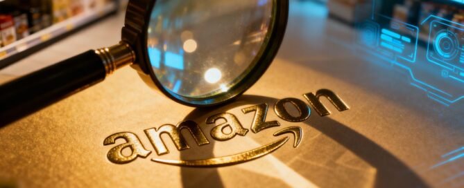 Magnifying glass over Amazon logo, competitor analysis concept.