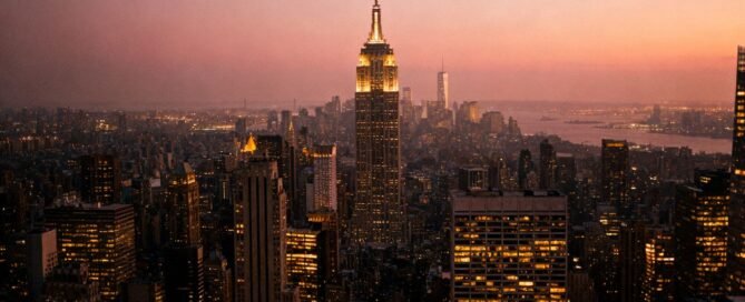 Cityscape at dusk with a prominent skyscraper.